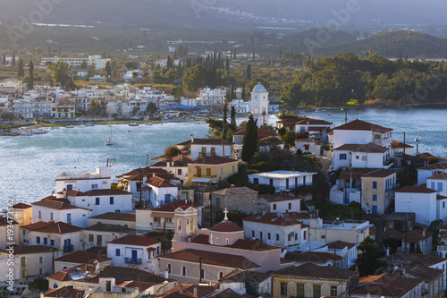View of the Chora village of Poros island and Galatas village in Peloponnese from a nearby hill, Greece. 
