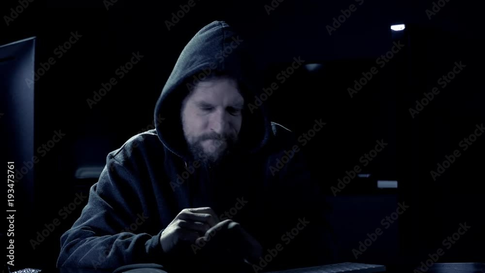 Male hacker tired at night coding