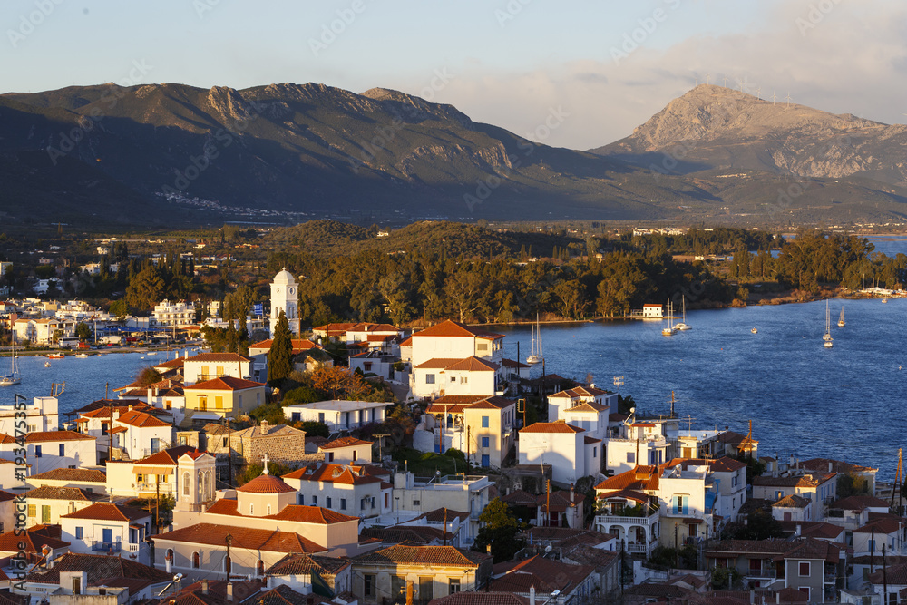 View of Poros island and Galatas village in Peloponnese, Greece.
View of Poros island and Galatas village in Peloponnese, Greece.