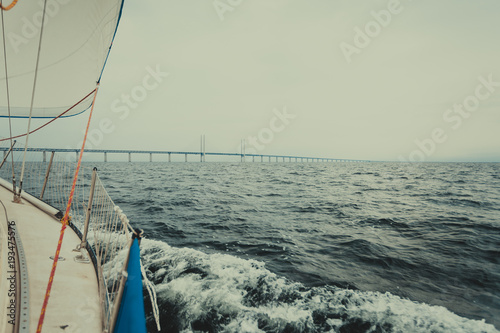 Yacht and oresund bridge between denmark sweden