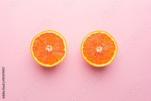Creative Concept. Two Orange on Light Pink Pastel Background, Top View.