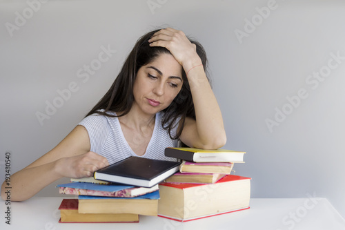 Tired and Sad Student Woman with Books Worried about Exams