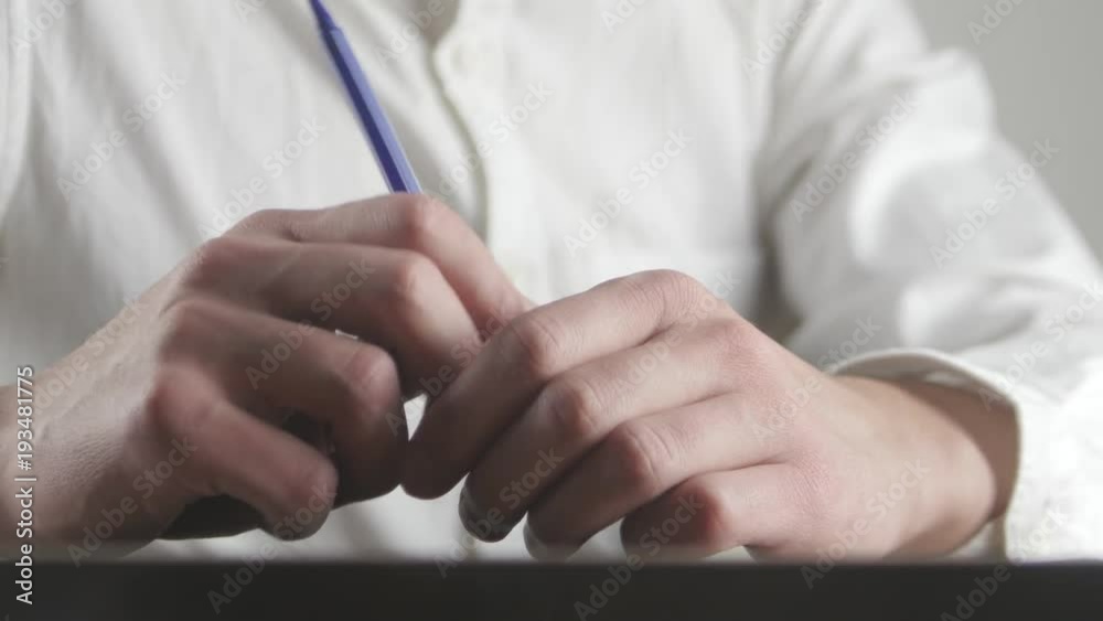 Close up hands of tired businessman waiting for something and makes nervous movements with the pen Close up hands of tired businessman waiting for something and makes nervous movements with the pen