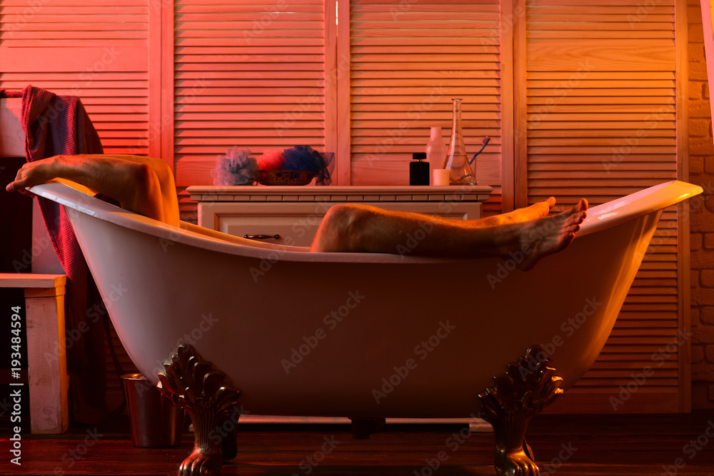 Macho lying naked in bathtub with legs and arms seen Stock Photo Adobe Stock