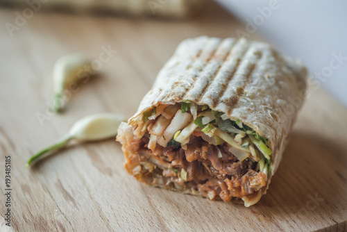 shawarma sandwich,doner kebab,gyro on a wooden table photo