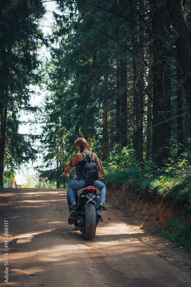 The motorcyclist and the girl on the road The motorcyclist and the girl on the road