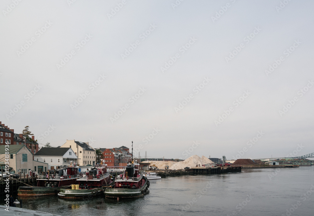 Three tugboats in a harbor