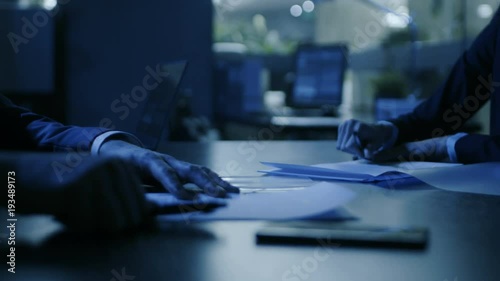 In the Dark Late Night Office Close-up on Hands of Businesswoman and Businessman while Signing Contracts and Shaking Hands. Shady Deal, Inside Trading. Stylish People in Modern Conference Room. 