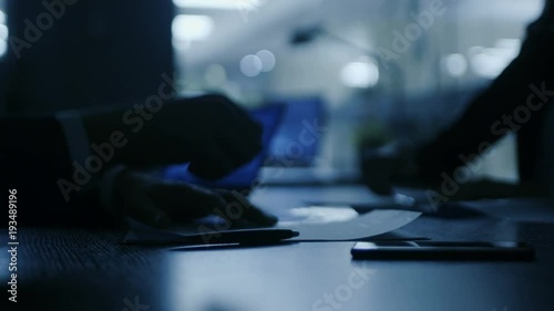 In the Dark Late Night Office Close-up on Hands of Businesswoman and Businessman while Signing Contracts and Shaking Hands. Shady Deal, Inside Trading. Stylish People in Modern Conference Room. 