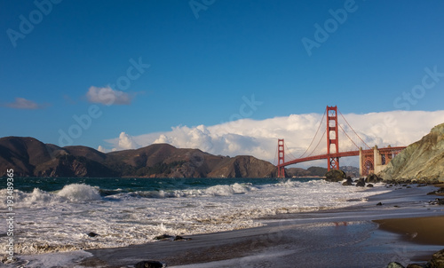 Golden Gate bridge on a sunny day with a blue sky and white clouds, San Francisco, California