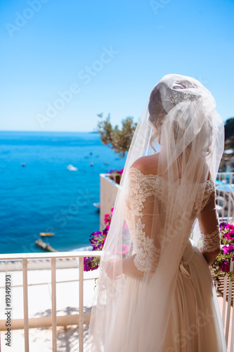 Tender romantic young blonde bride in honeymoon after wedding in Positano, Amalfi coast, Italy photo