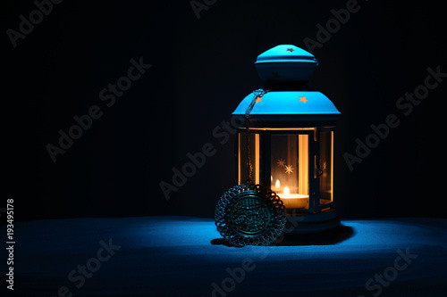 Holy month of Ramadan Karim background. Bright lantern on the sand with a copy space