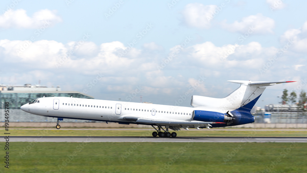 Soviet passenger airplane landing at runway, side view, horizontal, daytime/ three-engine medium-range narrow-body airliner/ Transportation, aviation concept Soviet passenger airplane landing at runway, side view, horizontal, daytime/ three-engine medium-range narrow-body airliner/ Transportation, aviation concept