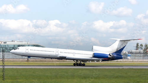 Soviet passenger airplane landing at runway, side view, horizontal, daytime/ three-engine medium-range narrow-body airliner/ Transportation, aviation concept