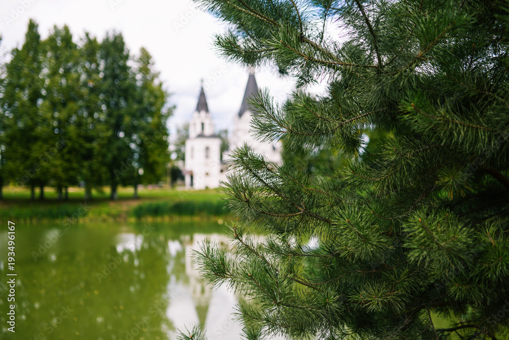 Church temple on a pond near trees