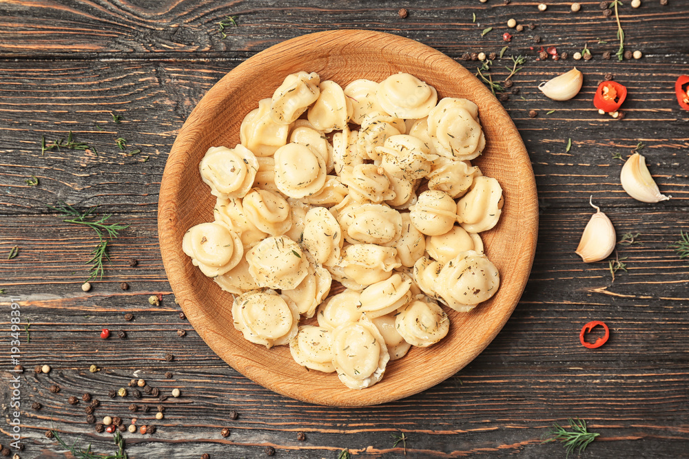 Fototapeta premium Plate with tasty meat dumplings on wooden background
