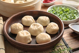 Plate with tasty baozi dumplings on table