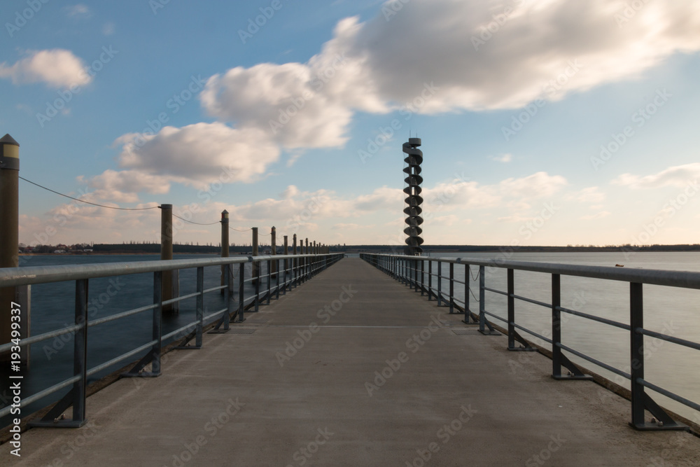 Bitterfeld, Germany - 22 February 2018: A gauge tower at the Great Goitzsche See in Bitterfeld, a recreational area in the chemical triangle of Bitterfeld-Wolfen. Bitterfeld, Germany - 22 February 2018: A gauge tower at the Great Goitzsche See in Bitterfeld, a recreational area in the chemical triangle of Bitterfeld-Wolfen.