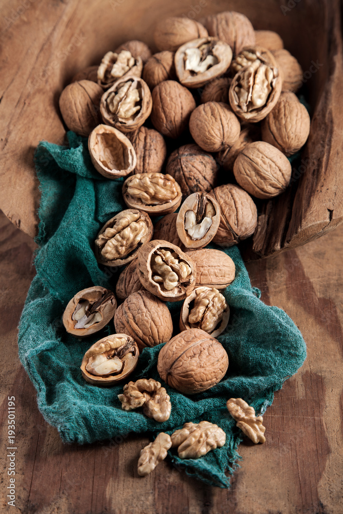 Beautifully presented walnuts on rusty wood table can be used as background Beautifully presented walnuts on rusty wood table can be used as background