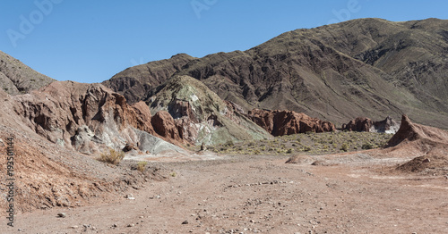 Rainbow Valley (Valle Arcoiris), in the Atacama Desert in Chile. The mineral rich rocks of the Domeyko mountains give the valley the varied colors from red to green. photo