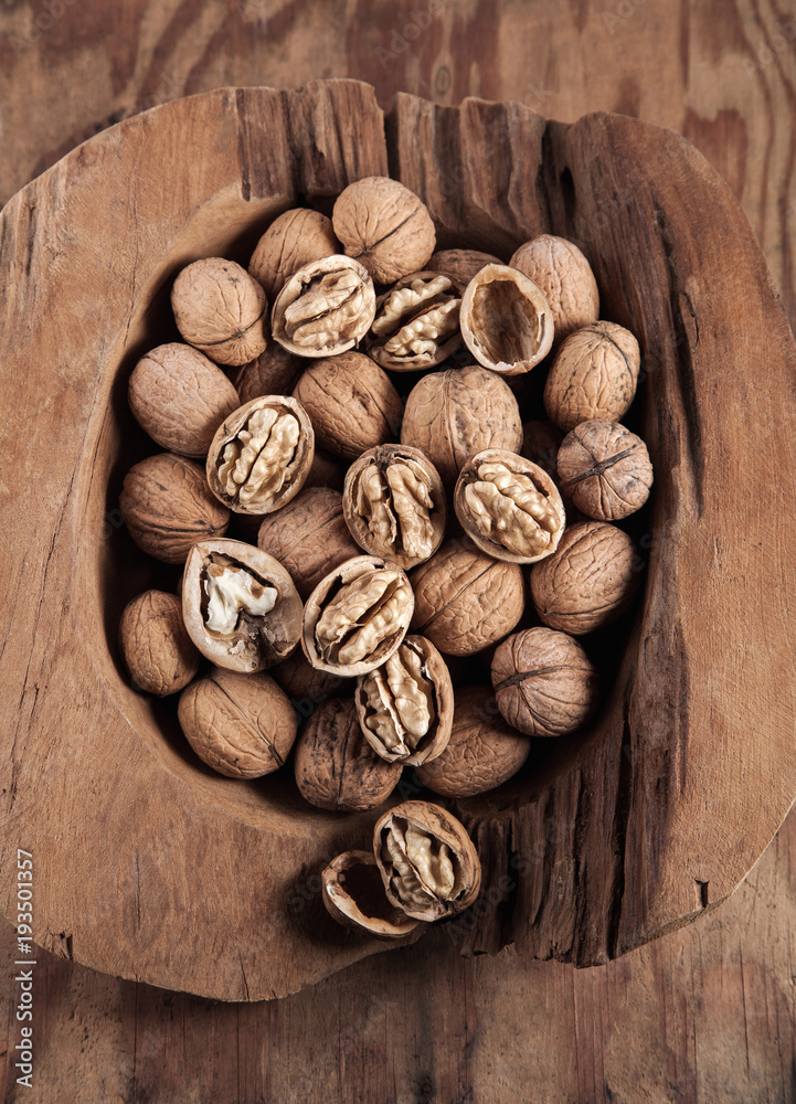 Beautifully presented walnuts on rusty wood table can be used as background Beautifully presented walnuts on rusty wood table can be used as background