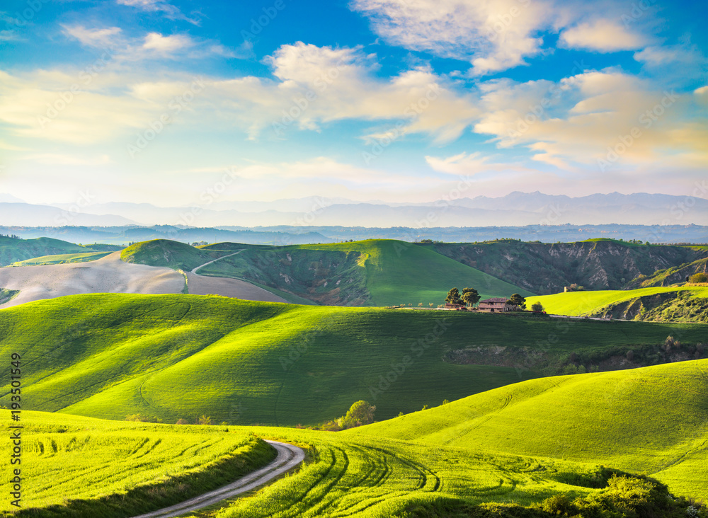 Tuscany, rural sunset landscape. Countryside farm, white road and cypress trees.