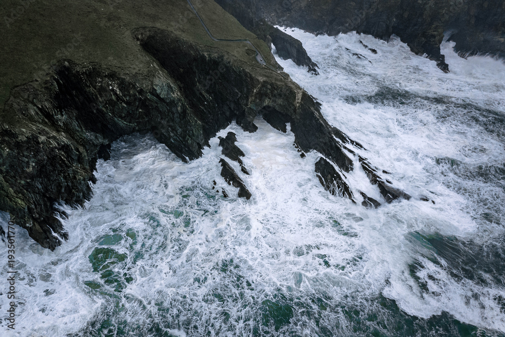 Cliffs at Mizen Head signal station on the south Ireland coast during heavy storm and crashing waves Cliffs at Mizen Head signal station on the south Ireland coast during heavy storm and crashing waves