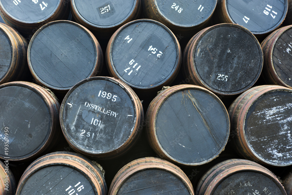 Stacked pile of old wooden barrels and casks at whisky distillery in Scotland Stacked pile of old wooden barrels and casks at whisky distillery in Scotland