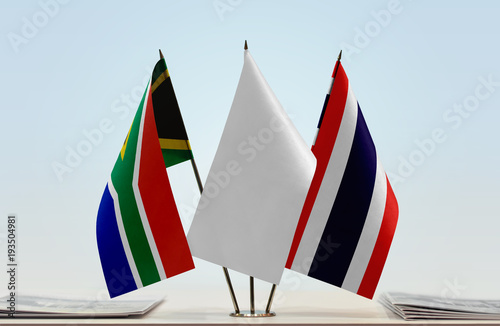 Flags of Republic of South Africa and Thailand with a white flag in the middle photo