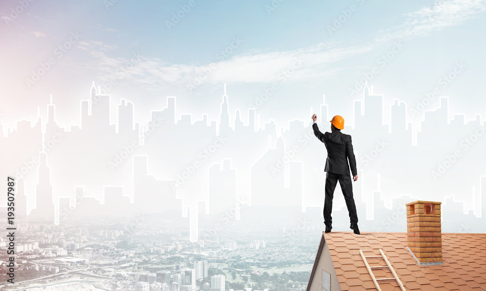Man architect draw silhouette of modern city on blue sky. Mixed media Man architect draw silhouette of modern city on blue sky. Mixed media