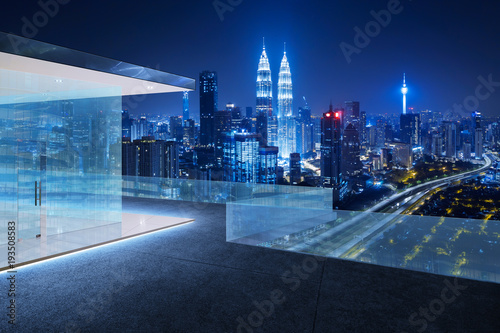 Obraz na plátne Glass railings and tile floor rooftops with night city skyline background