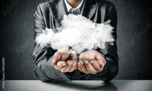 Woman presenting cloud in her hand.