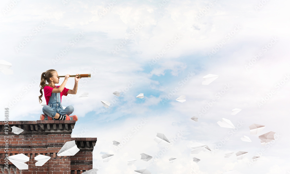 Concept of careless happy childhood with girl exploring this world