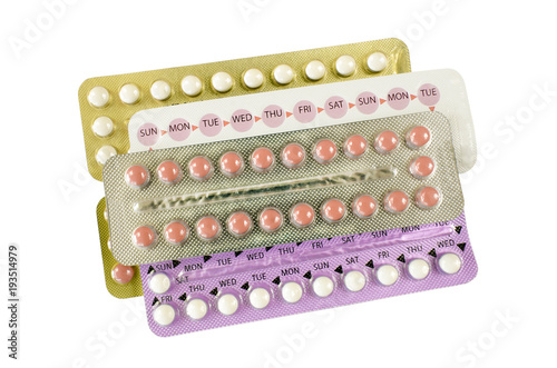 Oral contraceptive pill strips on white background.