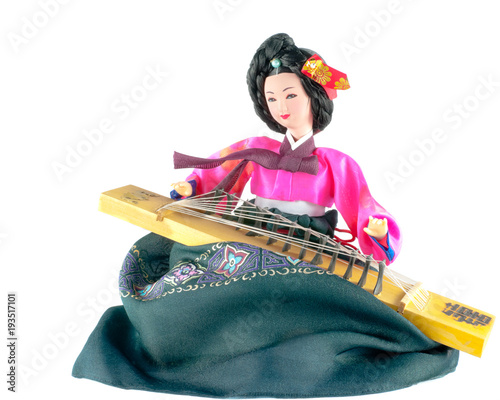 Korean Doll Wearing Traditional Costume and Playing Traditional Musical Instrument. Isolated on white. Square. photo