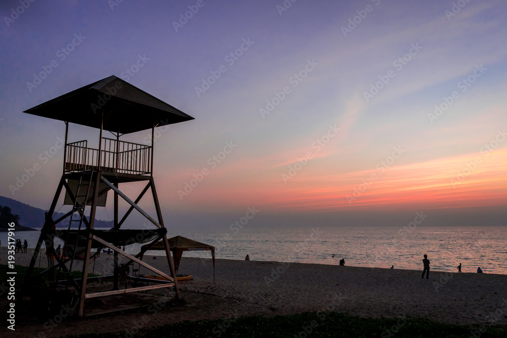 Lifeguard station over the seacoas with sunset on the beach, Evening time.