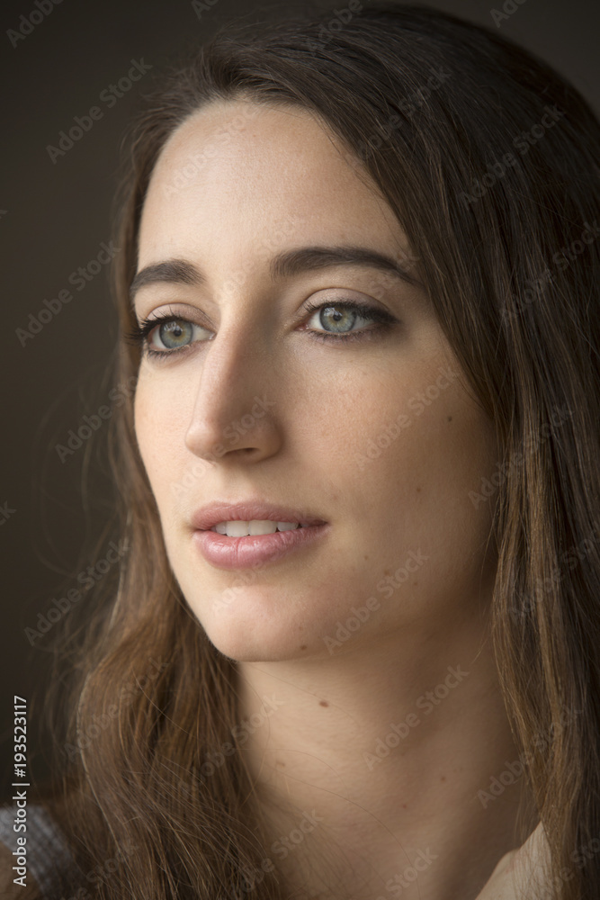 Head and shoulders portrait of young woman in windor light. Head and shoulders portrait of young woman in windor light.