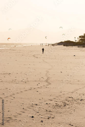 Silhouette of man running on the beach during sunset