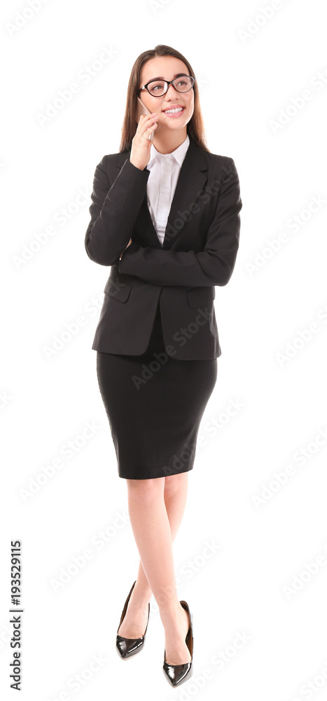 Beautiful young woman in elegant suit talking by mobile phone on white background Beautiful young woman in elegant suit talking by mobile phone on white background