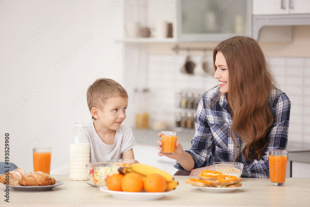 Mother with son having breakfast in kitchen Mother with son having breakfast in kitchen
