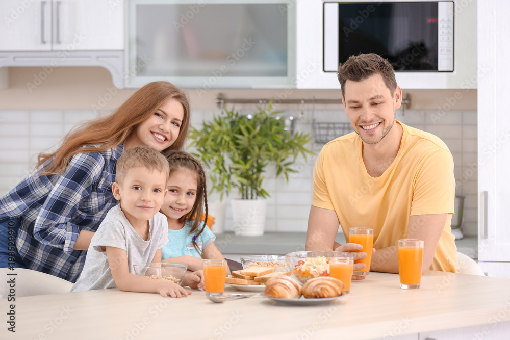 Happy family having breakfast in kitchen