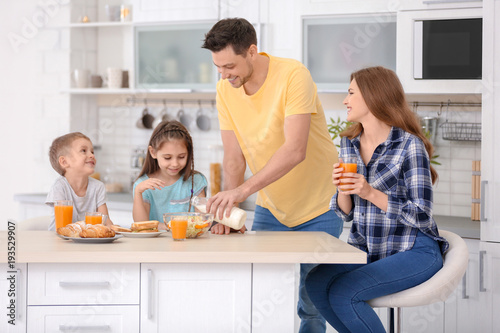 Happy family having breakfa...