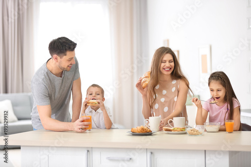 Happy family having breakfa...