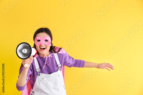 Young woman in superhero co...