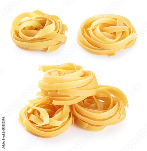 Raw tagliatelle pasta isolated on white background.