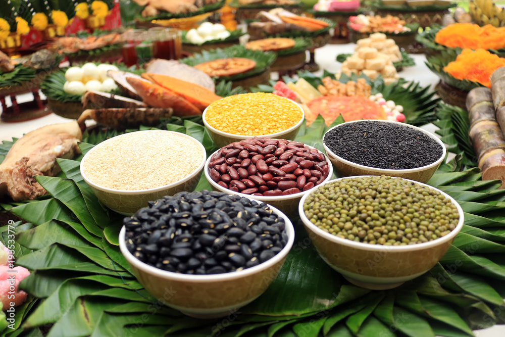 Whole grain, nut, bean, rice seed and other food in bowl for sacrificial offering in Thai traditional celebration.