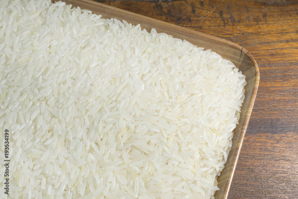 rice grain on wood table image for background. rice grain on wood table image for background.
