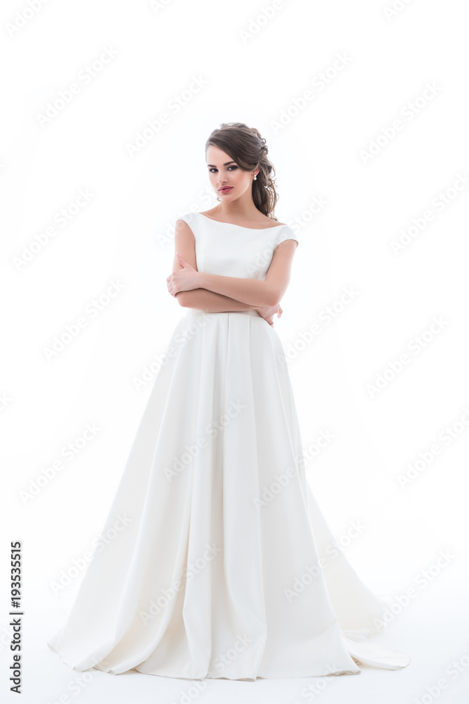 attractive bride posing in traditional wedding dress with crossed arms, isolated on white attractive bride posing in traditional wedding dress with crossed arms, isolated on white