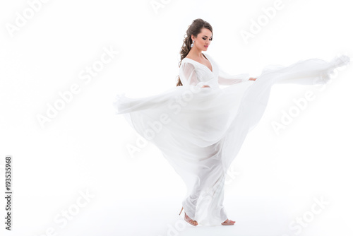 beautiful elegant bride dancing in wedding dress, isolated on white
