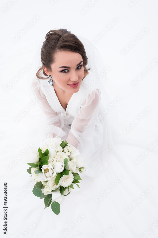 smiling bride in traditional white dress holding wedding bouquet, isolated on white smiling bride in traditional white dress holding wedding bouquet, isolated on white